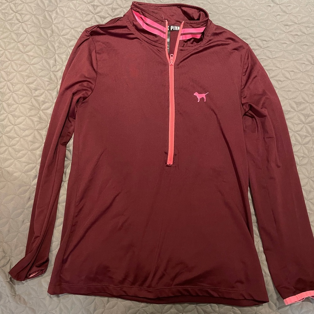 Pink quarter zip workout material shirt.